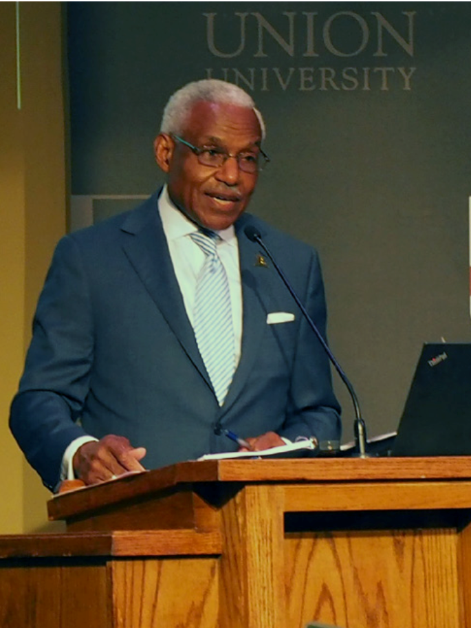 Man standing at a podium.